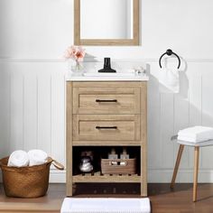 a bathroom with a sink, mirror and towels on the floor in front of it