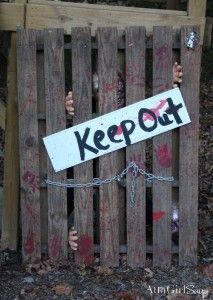 a sign that says keep out behind a wooden fence