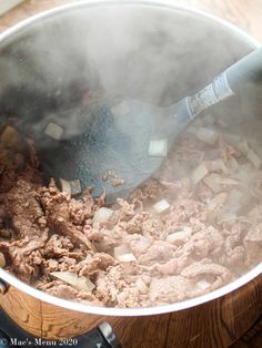 a large pot filled with meat and vegetables