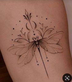 a woman's thigh with a flower tattoo on her leg and an arrow in the middle