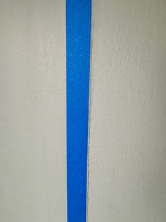 a white wall with blue tape on it