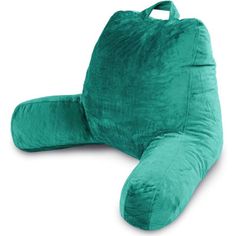 a large green pillow sitting on top of a white floor