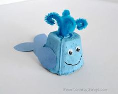 a small blue toy with a face on it