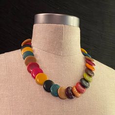 "This colorful matinee-length necklace features flat, disc-shaped beads and a hidden screw-closure. Gorgeous in shades of blue, green, purple, red, orange, and gold, it's just right for pairing with cozy fall colors or dressing up your favorite tee shirt and jeans.  Excellent vintage condition Beads:  1\"h x 1\"w x .25\"d Necklace: 20-21\"" Cheap Retro Beaded Necklaces With Colorful Beads, Cheap Retro Beaded Necklaces With Round Beads, 80s Beaded Necklace, Retro Multicolor Round Beads Necklace, Retro Multicolor Round Beads Jewelry, Retro Multicolor Round Bead Jewelry, Retro Multicolor Round Beaded Jewelry, Multicolor Round Retro Jewelry, Retro Multicolor Round Jewelry