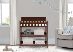 a baby crib in the corner of a room with a chair, blanket and other items