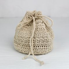 a crocheted bag sitting on top of a white table