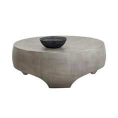 a round table with a bowl on top