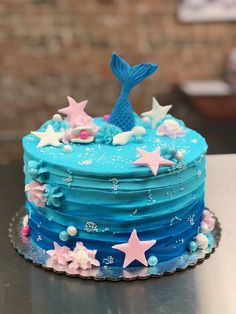 a blue and pink cake with stars on it