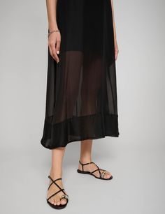 Black Long Layered semi-sheer a-line dress. 50% viscose, 50% polyesterSheer bottom hemBack zip closureTotal length 50'/125 cmModel wears size S is 5.9"/176 cmImported Flowy A-line Midi Dress In Viscose, Chic A-line Beach Slip Dress, Flowy Rayon Maxi Dress For Summer, Spring Evening Maxi Dress With Relaxed Fit, Spring Evening Maxi Dress With Relaxed Skirt, Chic Spring Rayon Slip Dress, Chic Rayon Slip Dress For Spring, Spring Breezy Midi Dress With Flowy Skirt, Breezy Midi-length Dress