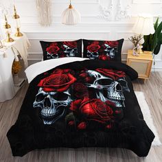 a bed with skulls and roses on it in a room next to a white wall