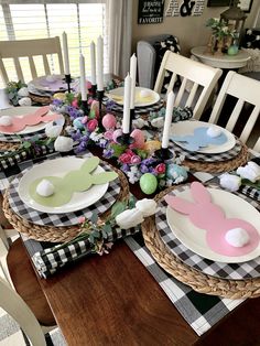 the table is set for easter dinner with bunny plates and napkins on top of it