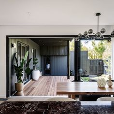 a table and chairs in front of a sliding glass door that leads to a deck