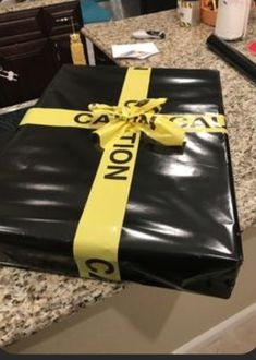 a black and yellow wrapped gift sitting on top of a counter