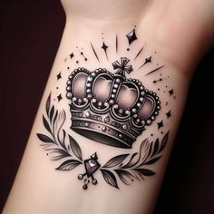 a tattoo with a crown on the wrist and stars around it, as well as an arrow