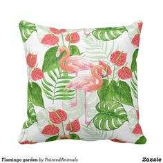 a pink flamingo pillow sitting on top of a green leaf covered pillow cover with red flowers