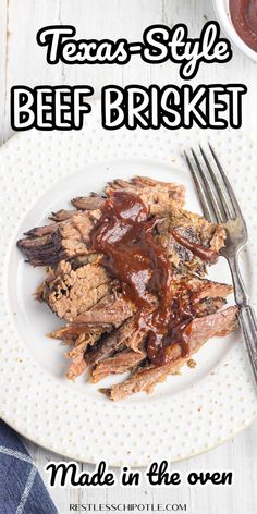 a white plate topped with meat covered in bbq sauce