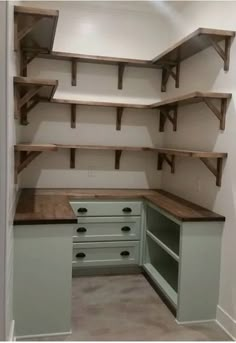 an empty walk in closet with shelves and drawers