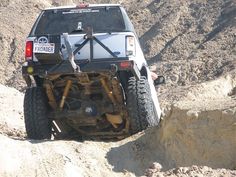 an off road vehicle is driving through the rocks in the desert with no wheels on it