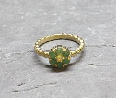 Gold Flower Ring set with Natural Emerald in smooth grade & natural green color, from Colombia, at 3mm each, with small Ethiopian Opal (centre stone), 1 Carat ring. Green Daisy Ring in Vintage inspired style made of Gold Vermeil ☞ thickest 18k Gold Plating on top of Solid 925 Sterling Silver ☞ made to last. Matching Earrings: www.etsy.com/uk/listing/868568007 Matching Pendant - please ask me May & October Birthstone - Genuine & Natural Stone ❀ ⌛Last Ring left ⌛ ☞ Choose your size ☞ I resize (bef Green Daisy, Natural Emerald Rings, Gold Flower Ring, Emerald Ring Gold, Jewelry Design Inspiration, Daisy Ring, Ring Opal, May Birthstone, October Birthstone