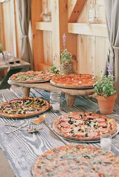 several different types of pizzas sitting on top of a table