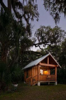 a small cabin in the woods at night