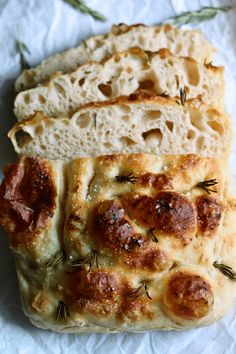 two slices of bread with meat and herbs on them