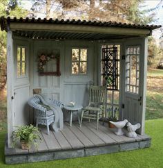 a doll house with furniture and accessories on the porch in front of an open door