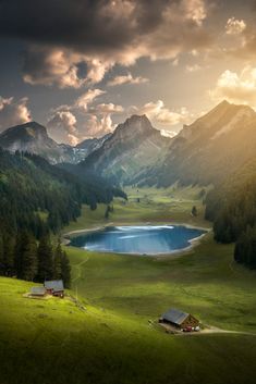 a mountain landscape with a lake in the foreground