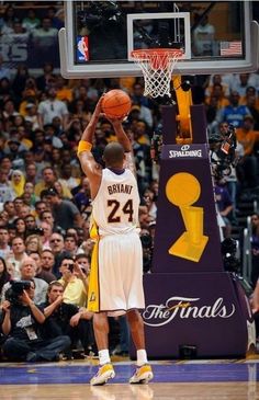 the basketball player is getting ready to dunk the ball in front of an audience