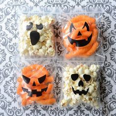 four plastic bags filled with halloween treats on top of a table