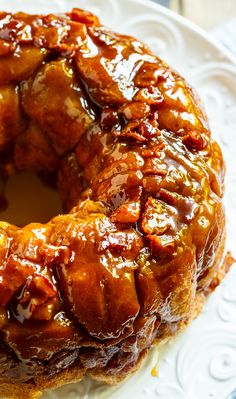 a bundt cake on a white plate covered in caramel sauce