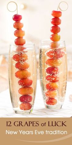 two wine glasses filled with fruit on top of each other and the words, 12 grapes of luck new years eve tradition