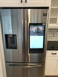 a stainless steel refrigerator in a white kitchen