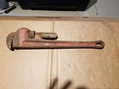 an old wrench sitting on top of a cardboard box