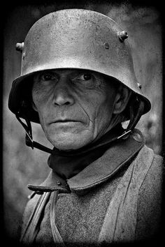 black and white photograph of an old man wearing a helmet