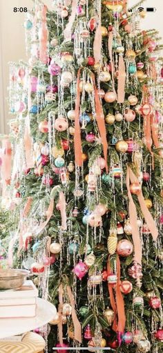 a christmas tree decorated with ornaments and ribbons