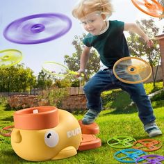 a young boy is playing with toys in the grass and flying disc tossers around him