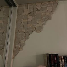 a book shelf with several books and a torn piece of paper on top of it