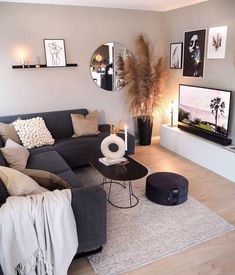 a living room filled with furniture and pictures on the wall