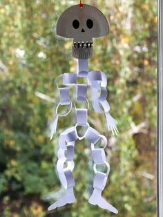 a paper skeleton is hanging from a window