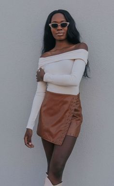 Looking for the cutest skirt of the season? The Give Me the Light Skirt is a high rise, wrap brown leather skirt with bronze studs and built in shorts. Pair with a bodysuit and tall boots. 

Heather is 5'9" and is wearing size small

size small measurements: 28" waist | 14.5" length

100% polyester lining | 100% polyurethane shell



PRODUCTS ON SALE ARE FINAL SALE! Feel free to email us at orders@shopriffraff.com or DM us with any questions regarding fit, styling, or our return poli Light Brown Leather Skirt Outfit, Brown Mini Leather Skirt Outfit, Brown Leather Skirt Outfit Fall, Mini Leather Skirt Outfit, Leather Skirt Outfit Fall, Tall Brown Boots Outfit, Fall Skirt Outfits With Boots, Brown Leather Pencil Skirt, Brown Leather Skirt Outfit