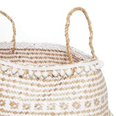 a white and brown basket with two handles