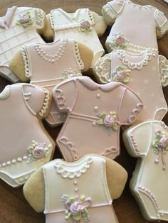 decorated cookies in the shape of baby's bodysuits