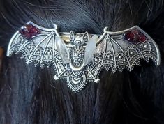 Whimsical Hand saudred stainless steel Bat hair pin. Featuring gorgeous detail in the bat pattern with added mini lumerian points, and garnet gemstone  this hair pin is on the heavier side so I'd recommend using it for thicker hair Bats Nest Hair, Vampire Jewelry, Vampire Fashion, Bat Jewelry, Outfit References, Alt Clothes, Bat Pattern, Crystal Hair Pins, Reno Nv