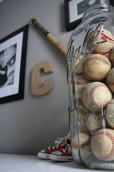 a jar filled with baseballs sitting on top of a table