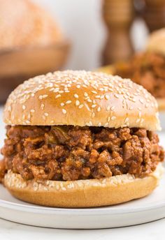 a sloppy joe sandwich on a plate with a fork