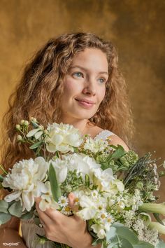 a woman holding a bouquet of flowers in her hands