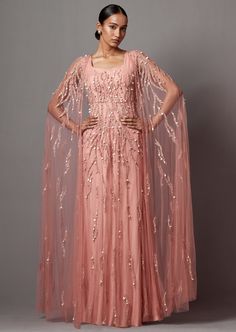 Dusty Rose cape gown in net fabric, it is hand embroidered. Cape is detachable. Dusty Rose Gown, Detachable Cape, Cape For Women, Embroidered Cape, Cape Gown, Embellished Gown, Cape Sleeves, Net Fabric