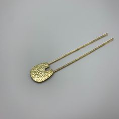 This hair fork is hammered to catch the light and is perfect to accent your up-do. Inserting the hair fork is simple... first, make a bun then weave the hair fork through to hold it tight. Check out the rest of our hair forks/pins: https://www.etsy.com/ca/shop/MilaVardi?ref=seller-platform-mcnav%C2%A7ion_id§ion_id=30402688 Product Info: Made with 12 gauge solid hammered brass Wire thickness: 2.06mm Length: 4 1/2" Width of pin: 5/8" Width of the horseshoe: 3/4" Lenght of the horseshoe: 1 3/4" The Handmade Gold Hair Accessories For Gifts, Adjustable Gold Hair Accessories For Gifts, Adjustable Gold Hair Accessories As Gift, French Hairpin, French Hair Pin, Hair Forks, Bun Holder, Hair Fork, Brass Pin