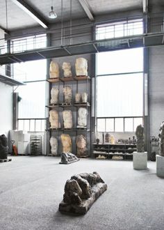 a large room filled with lots of stone sculptures